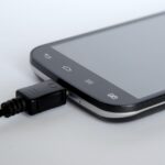 Caricabatterie del telefono attaccato a una presa elettrica con cavo disordinato.